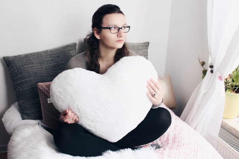 Girl with heart pillow